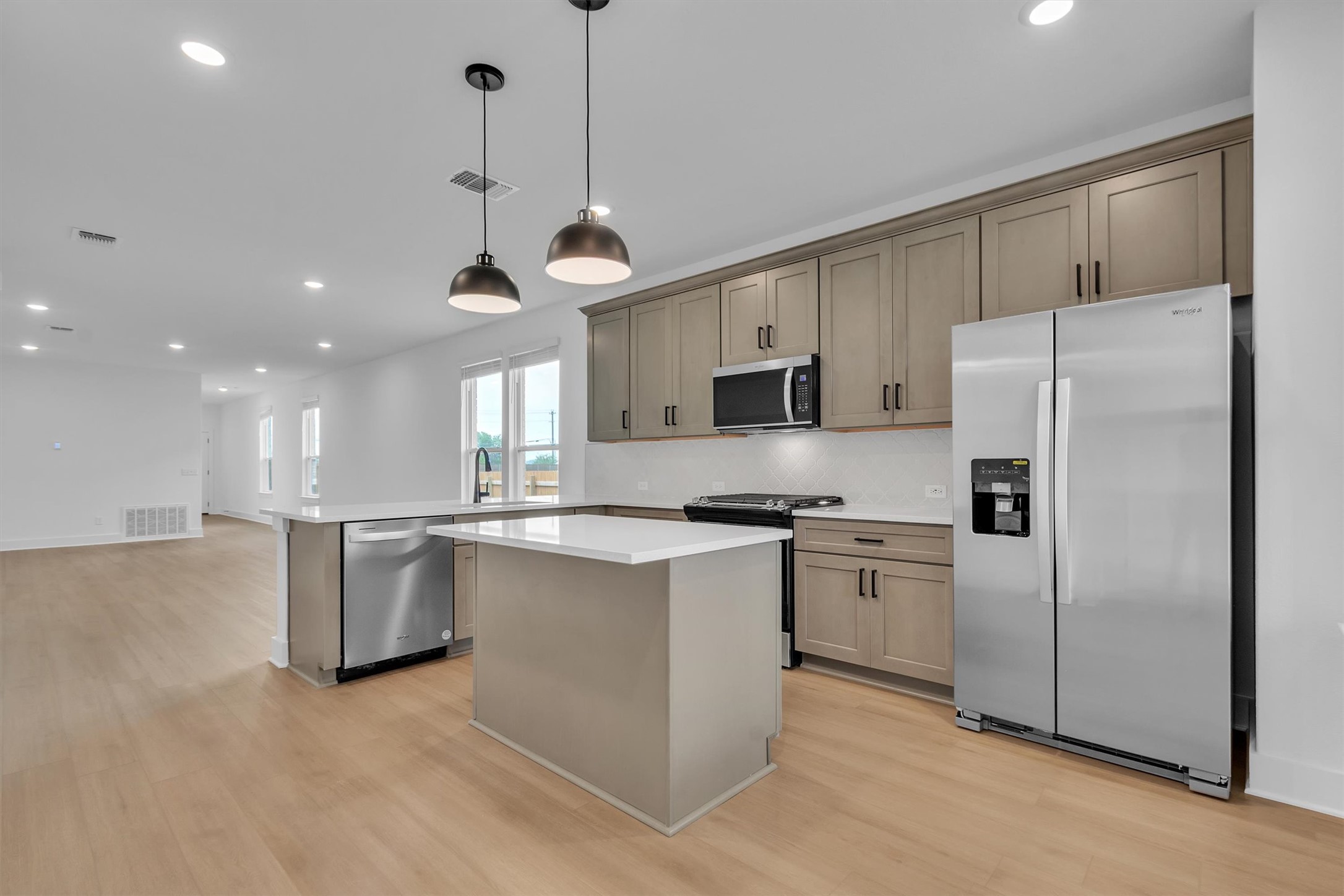 368 Bridge Deck Loop Kyle, TX 78640 - Photo 10 of 40 Kitchen with stainless steel appliances, light wood-type flooring, recessed lighting, a peninsula, and a kitchen island