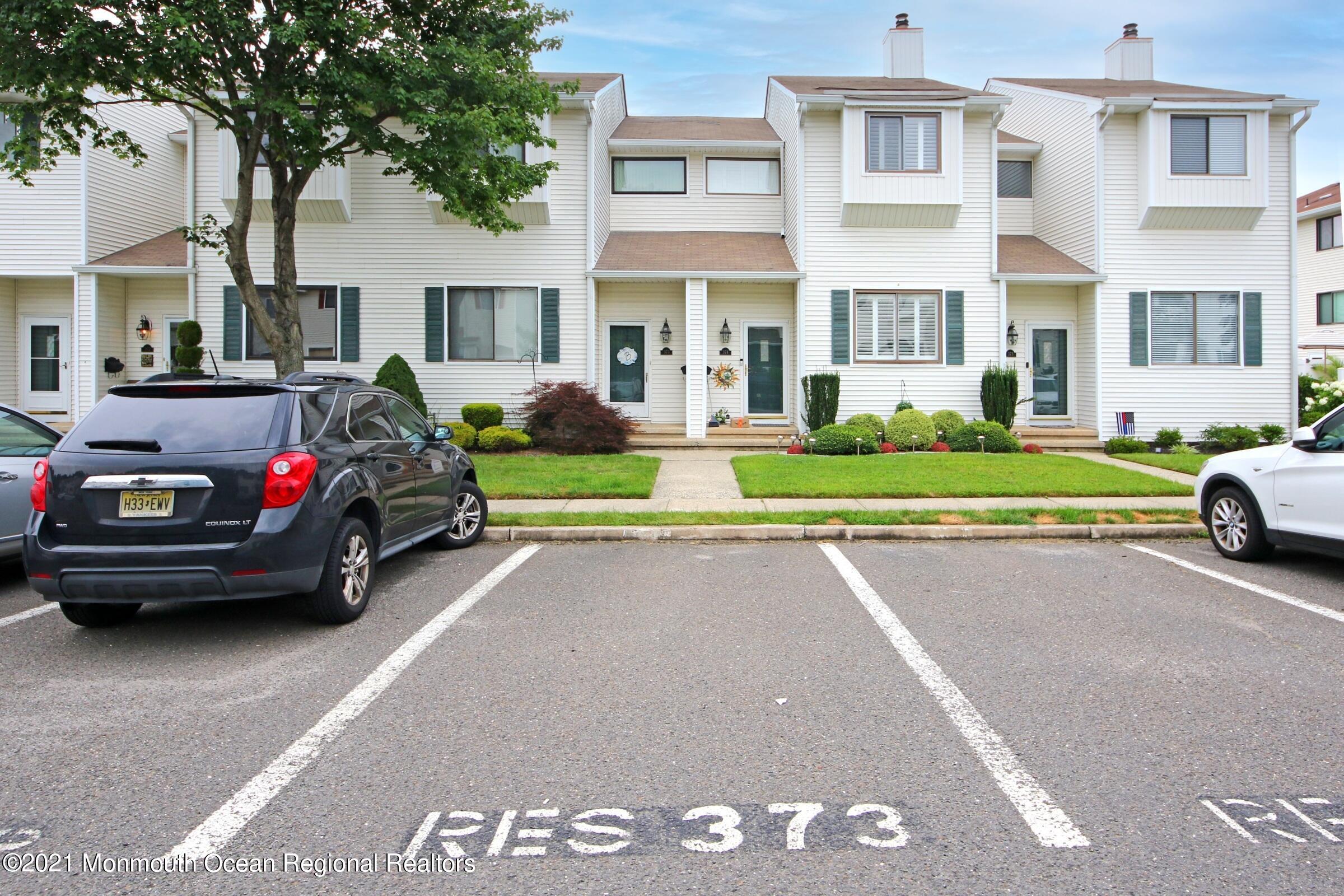 373 Middlewood Road Middletown, NJ 07748 - Photo 2 of 28 a view of a street that has couple of cars parked on the road