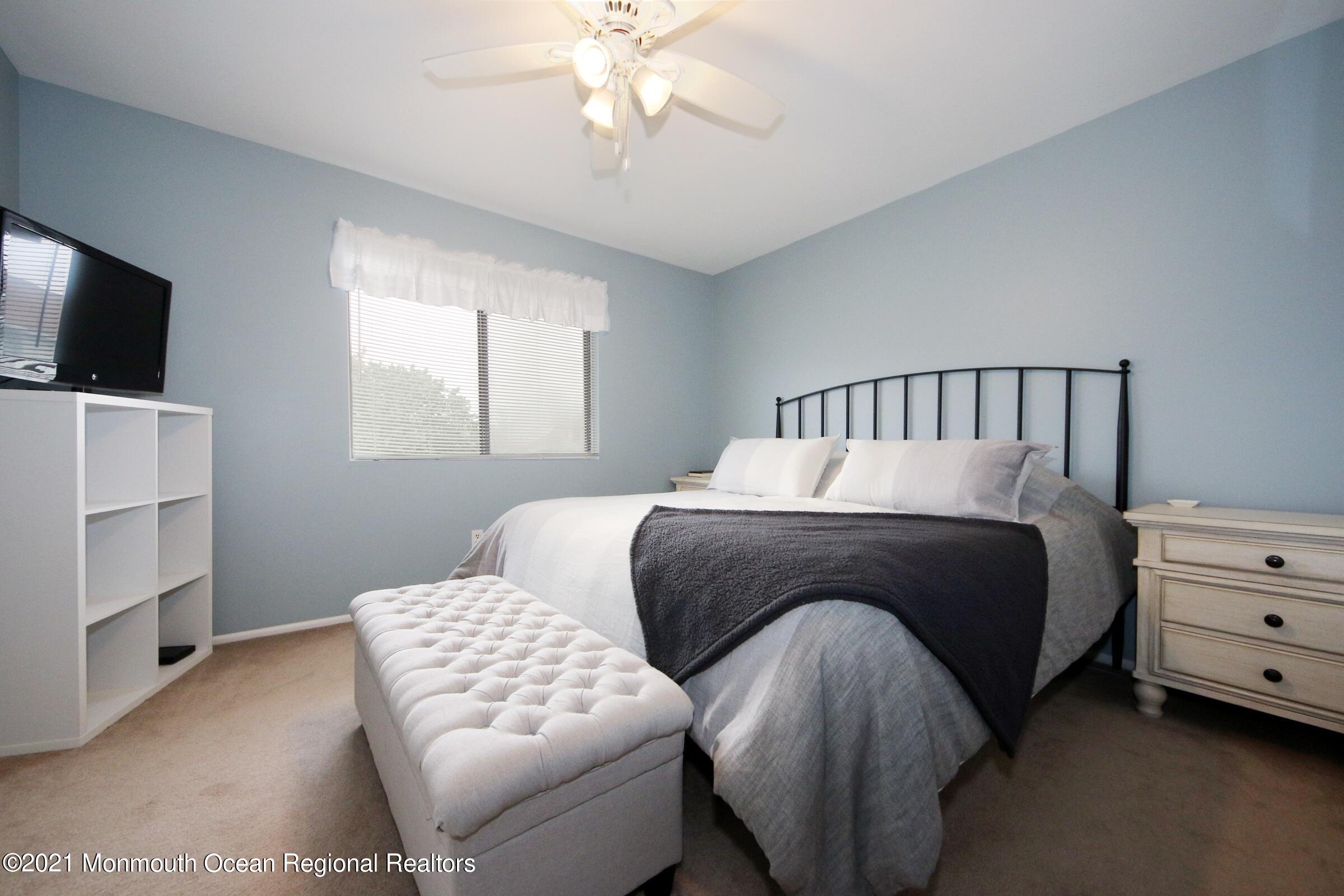 373 Middlewood Road Middletown, NJ 07748 - Photo 15 of 28 a bedroom with a bed and a flat screen tv