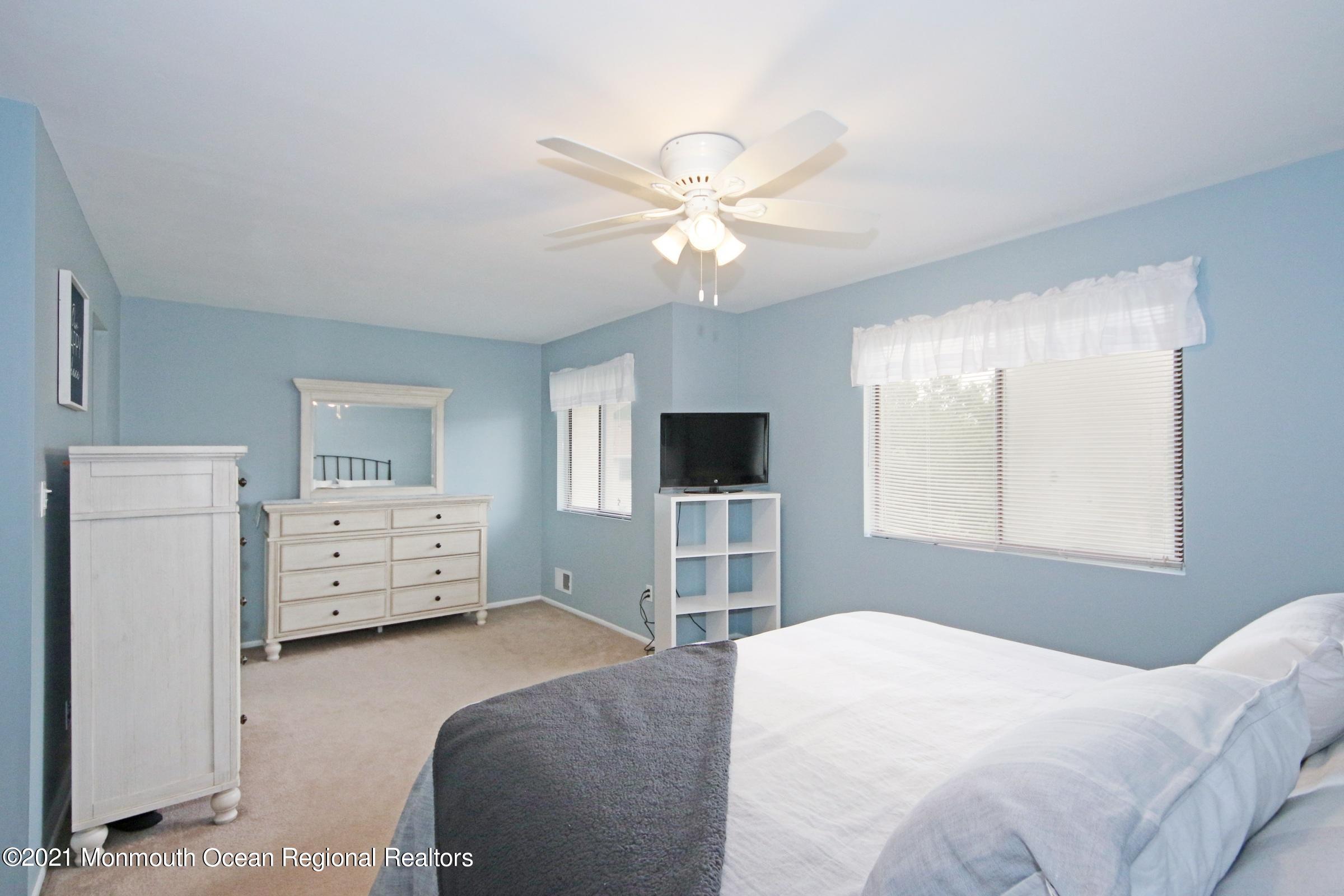 373 Middlewood Road Middletown, NJ 07748 - Photo 17 of 28 a bedroom with a bed and a flat screen tv