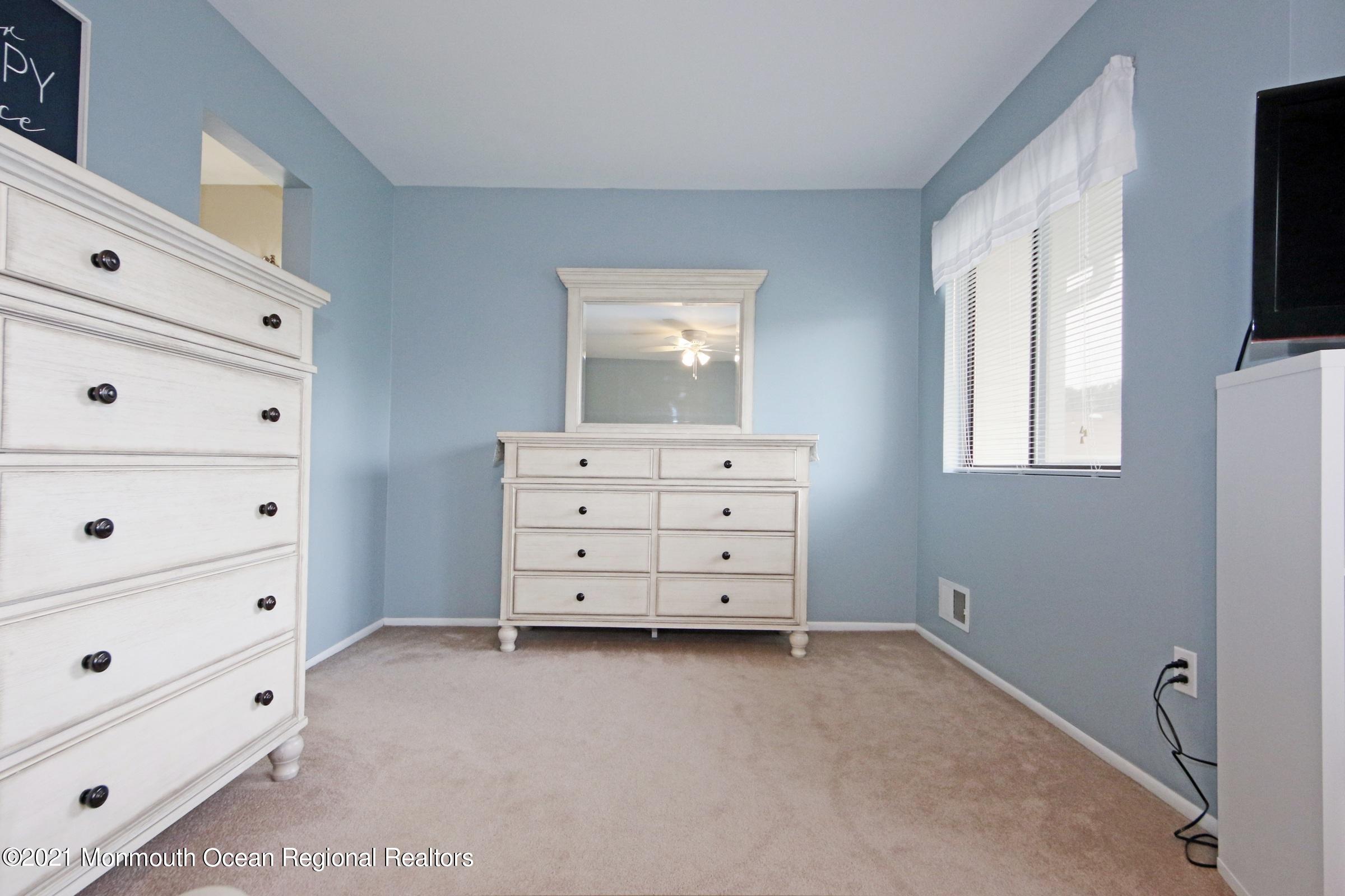 373 Middlewood Road Middletown, NJ 07748 - Photo 19 of 28 a bedroom with a bed and a tv