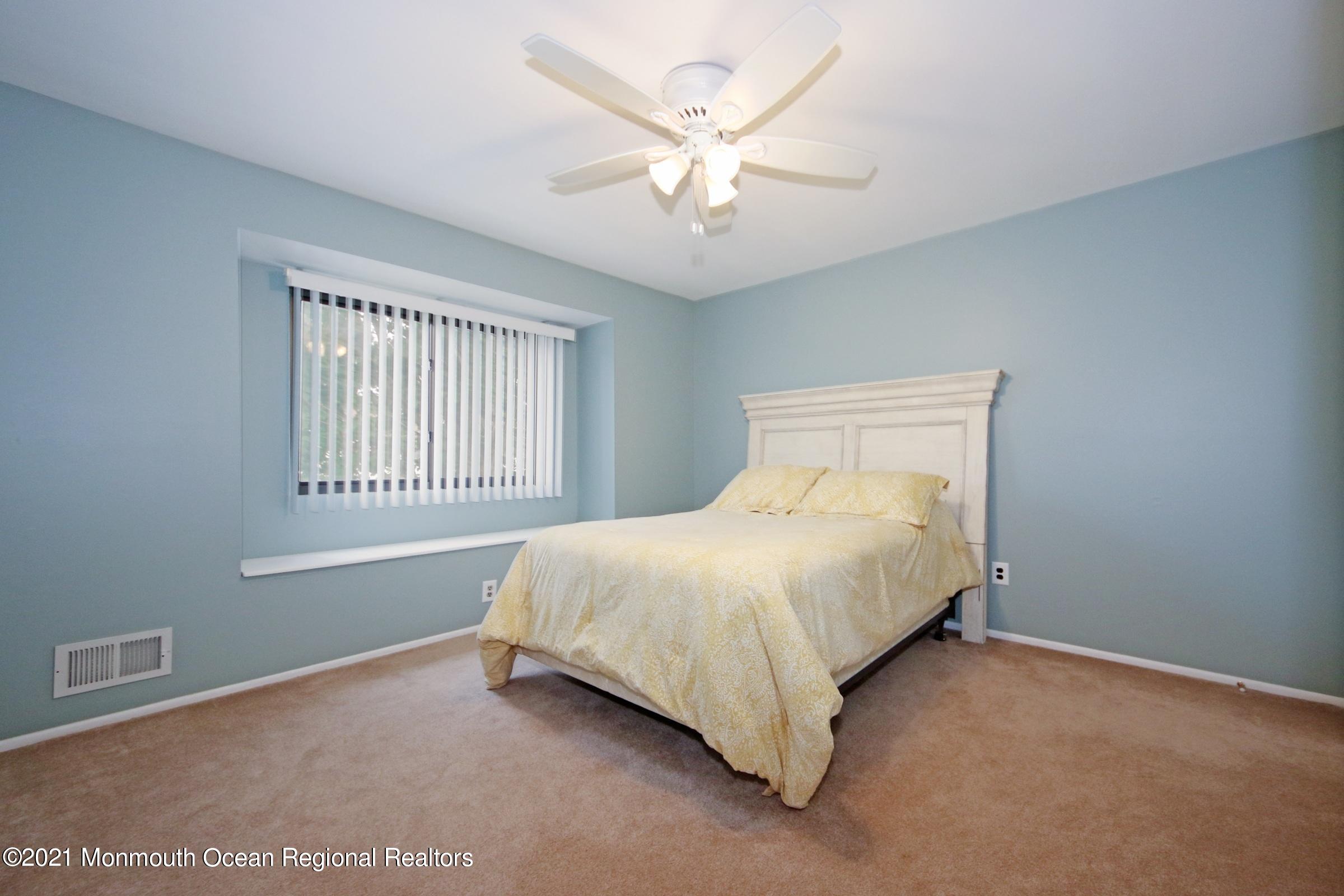 373 Middlewood Road Middletown, NJ 07748 - Photo 20 of 28 a bed sitting in a bedroom next to a window