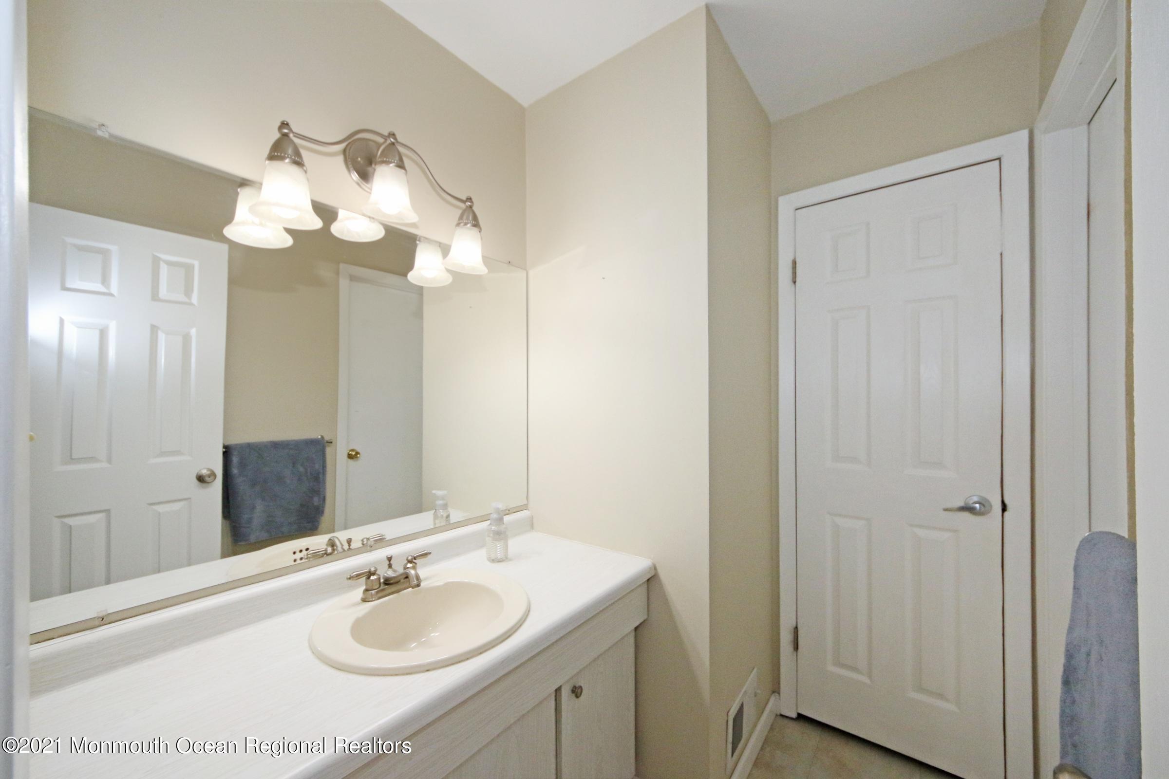 373 Middlewood Road Middletown, NJ 07748 - Photo 22 of 28 a bathroom with a sink vanity and a mirror