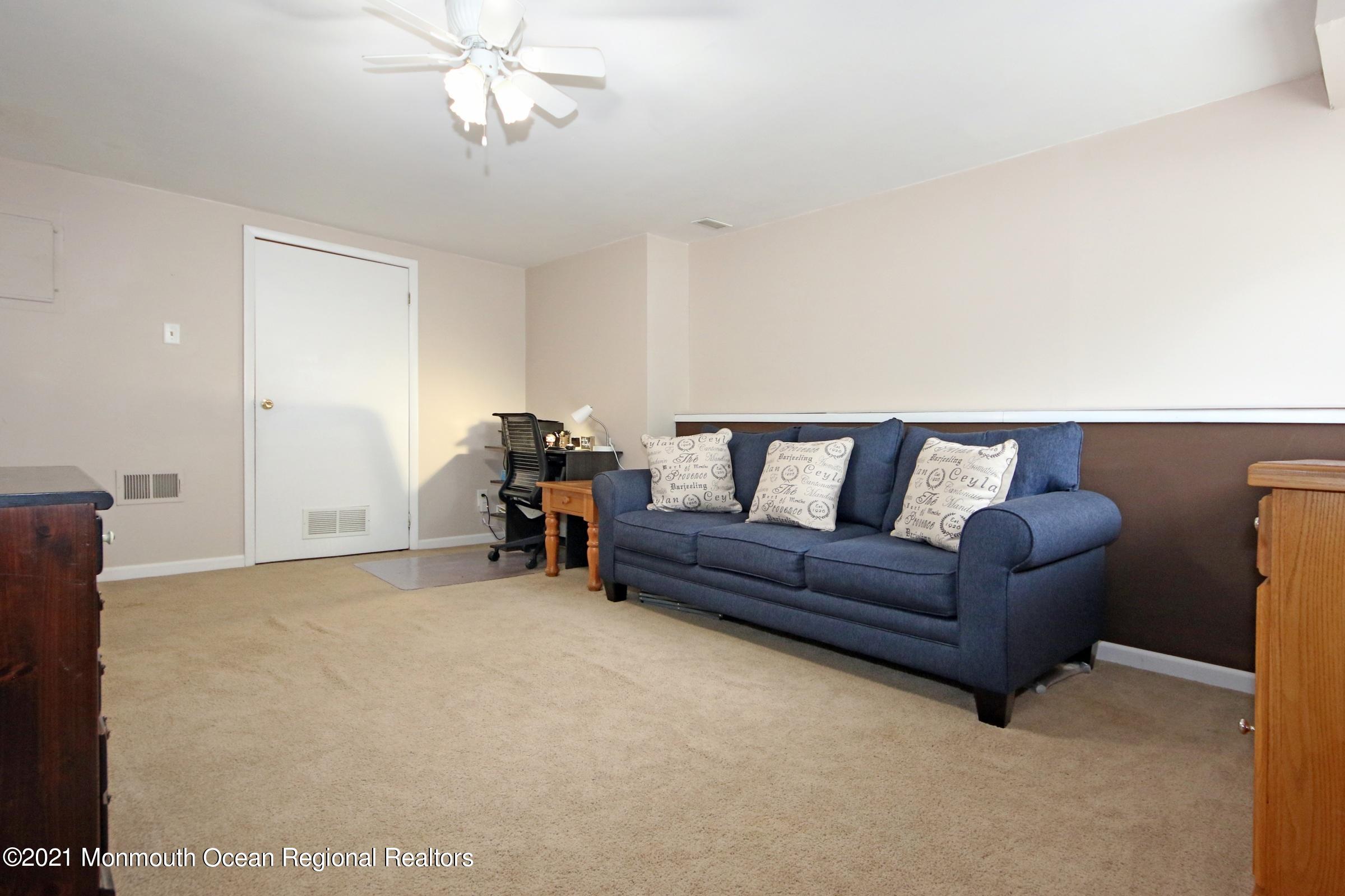 373 Middlewood Road Middletown, NJ 07748 - Photo 24 of 28 a living room with furniture and a chandelier