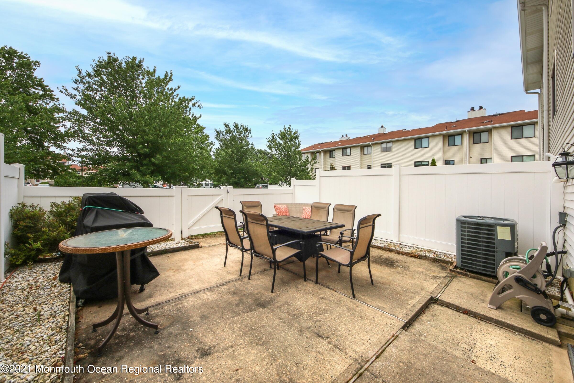 373 Middlewood Road Middletown, NJ 07748 - Photo 25 of 28 a view of a patio with table and chairs and potted plants