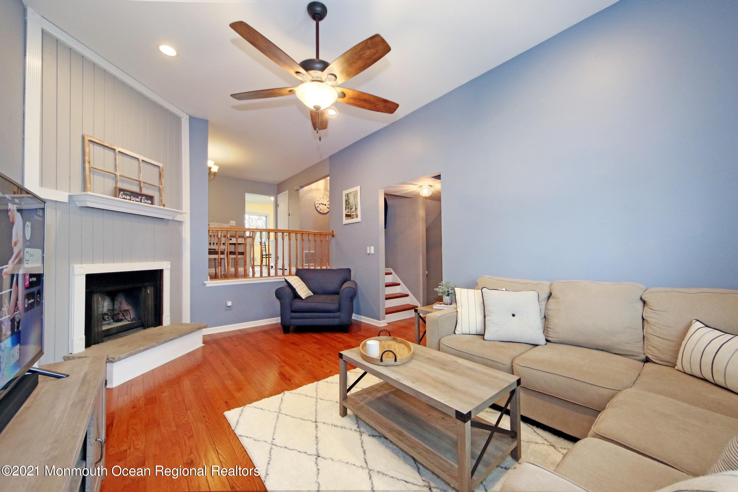 373 Middlewood Road Middletown, NJ 07748 - Photo 4 of 28 a living room with furniture and a fireplace