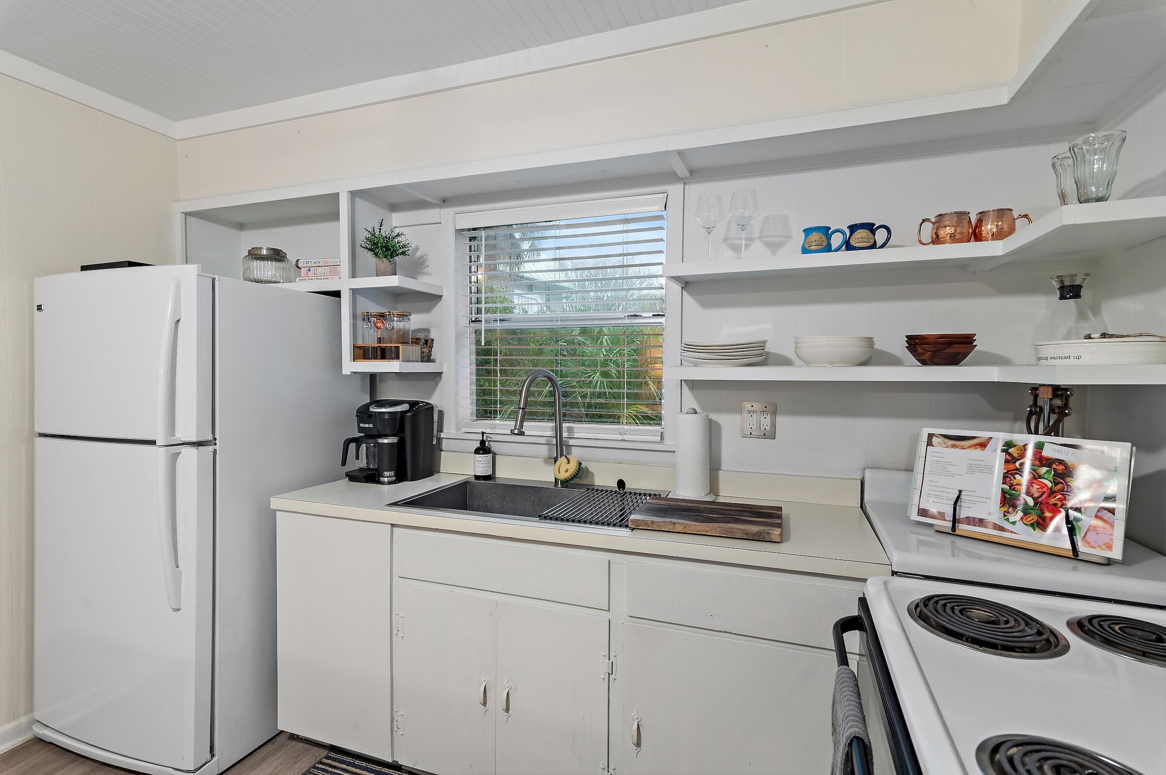 181 Gulf Point Road Santa Rosa Beach, FL 32459 - Photo 17 of 21 a kitchen with a refrigerator and a sink