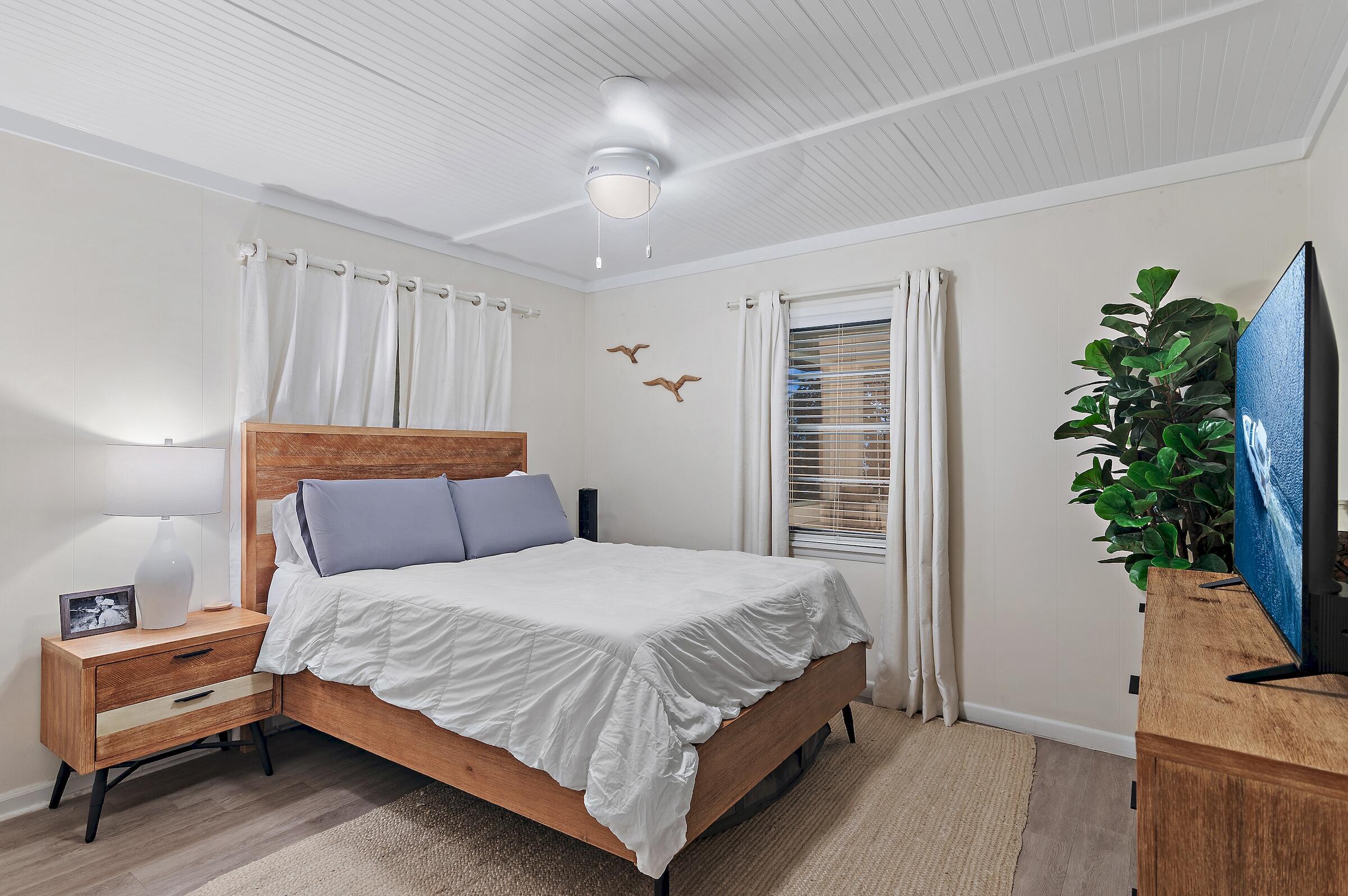181 Gulf Point Road Santa Rosa Beach, FL 32459 - Photo 19 of 21 a bedroom with a bed and a potted plant on the dresser