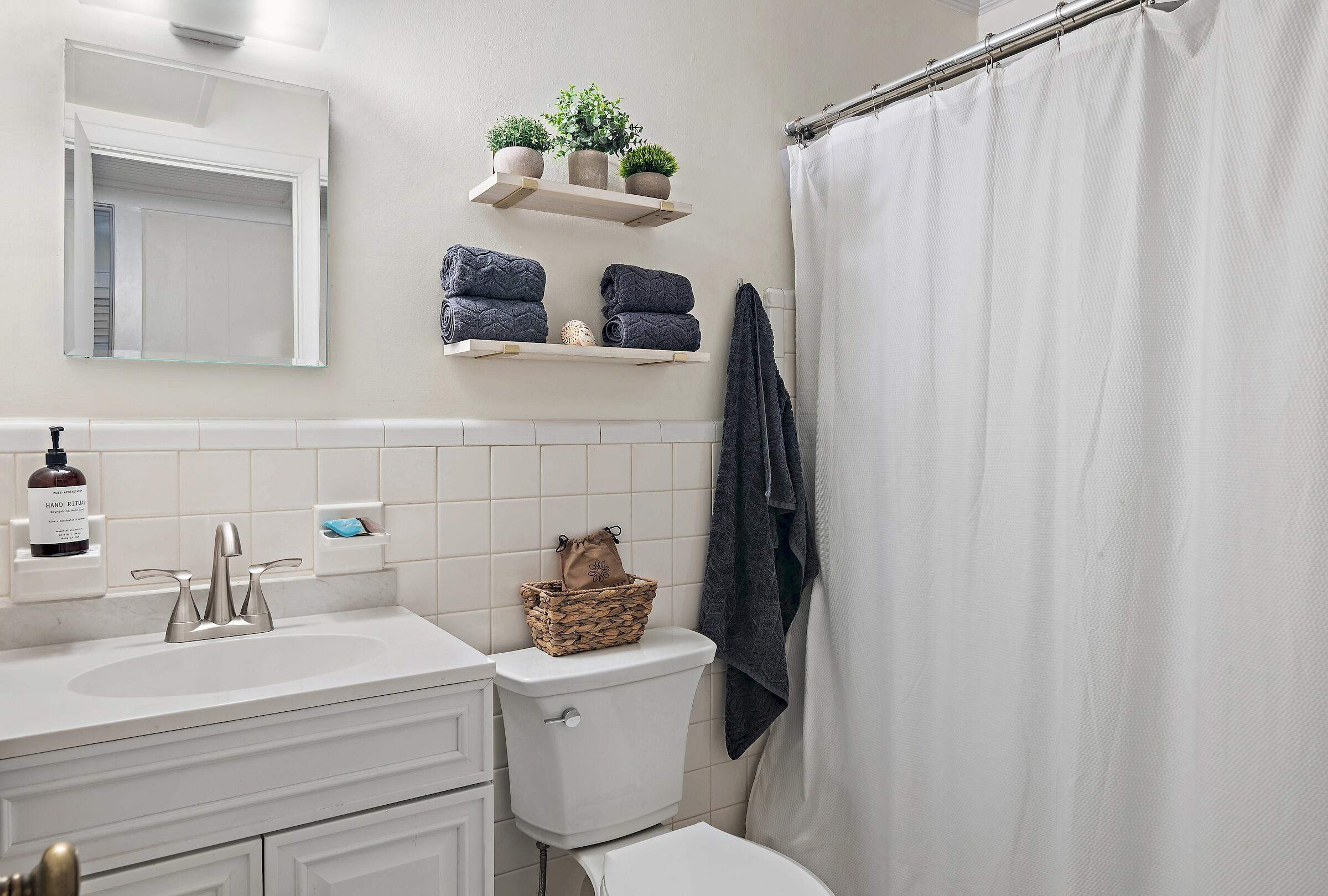 181 Gulf Point Road Santa Rosa Beach, FL 32459 - Photo 20 of 21 a bathroom with a sink a toilet and a mirror