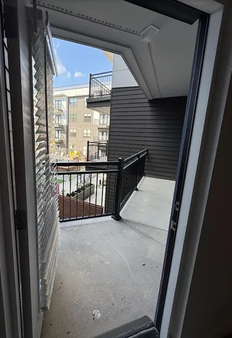 a living room with furniture wooden floor and large windows