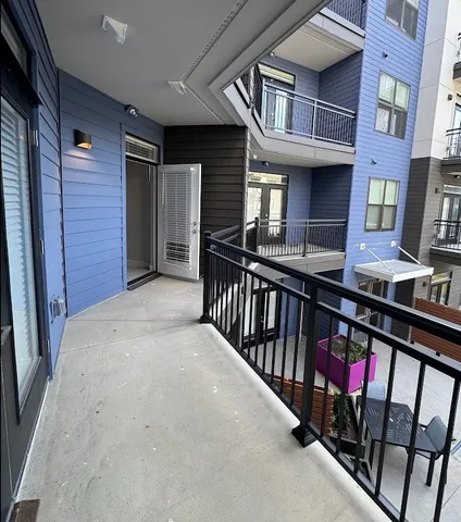 a kitchen with stainless steel appliances kitchen island granite countertop a refrigerator a sink and a stove top oven