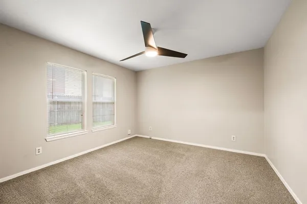 an empty room with windows and closet