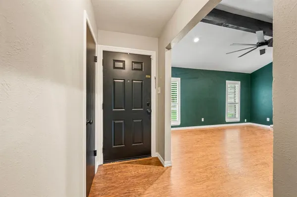 a view of an empty room with a fireplace and a window