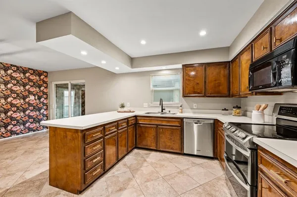 a kitchen with a sink stainless steel appliances and cabinets