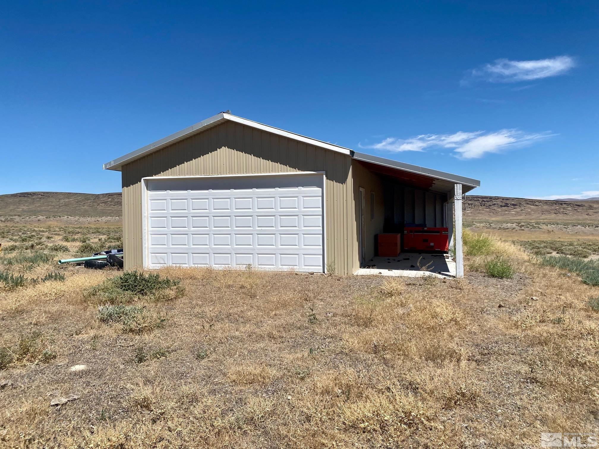 200 Transfer Site Road Crescent Valley, NV 89821 - Photo 1 of 18 a view of yellow house with a yard