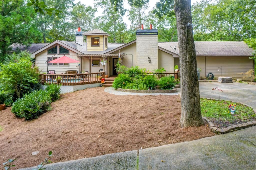 1350 Riverside Road Roswell, GA 30076 - Photo 1 of 1 a front view of a house with a yard and potted plants
