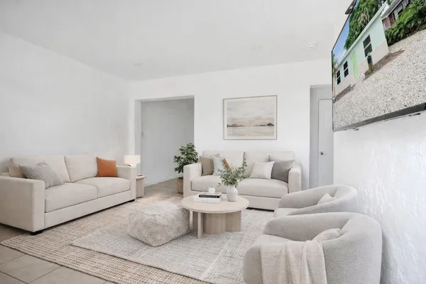 a living room with furniture and white walls