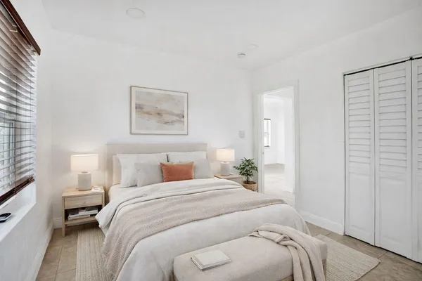 a bedroom with a bed and a couch