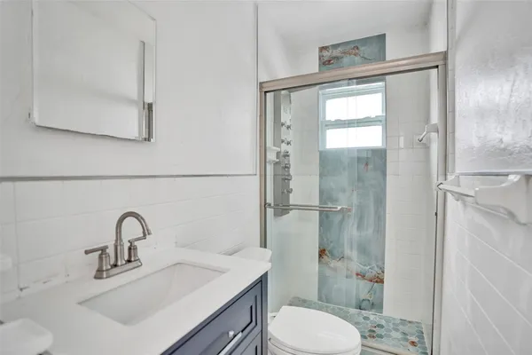 a bathroom with a sink toilet and a mirror