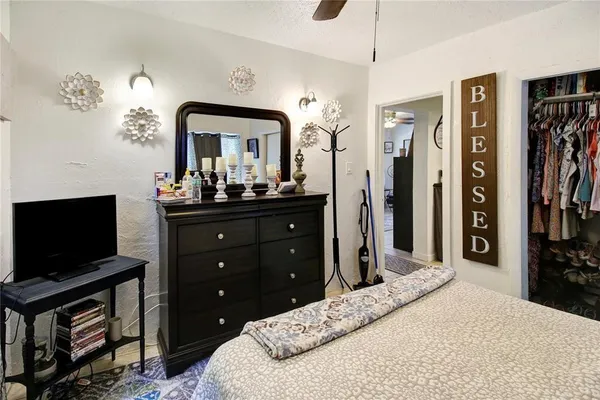 a bedroom with a bed and a flat screen tv