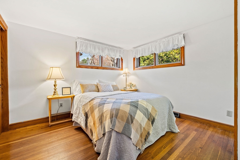 1 Ledgewood Road Wilmington, MA 01887 - Photo 17 of 36 a bedroom with a bed and wooden floor