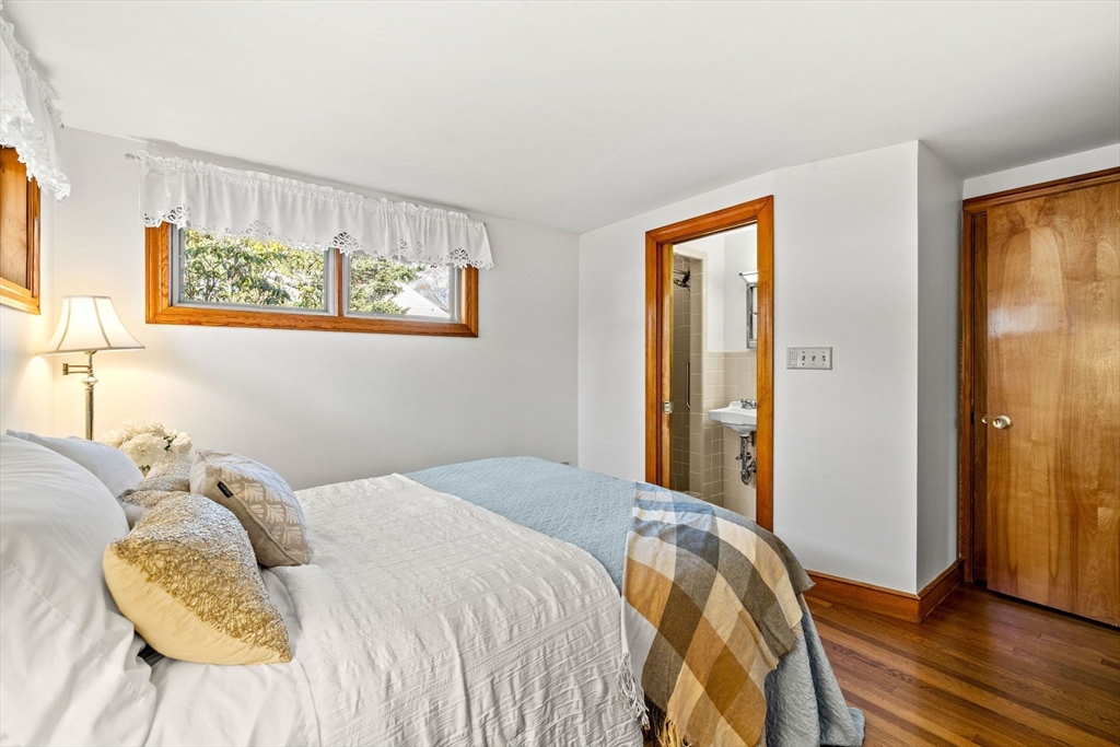1 Ledgewood Road Wilmington, MA 01887 - Photo 18 of 36 a bedroom with a bed and wooden floor