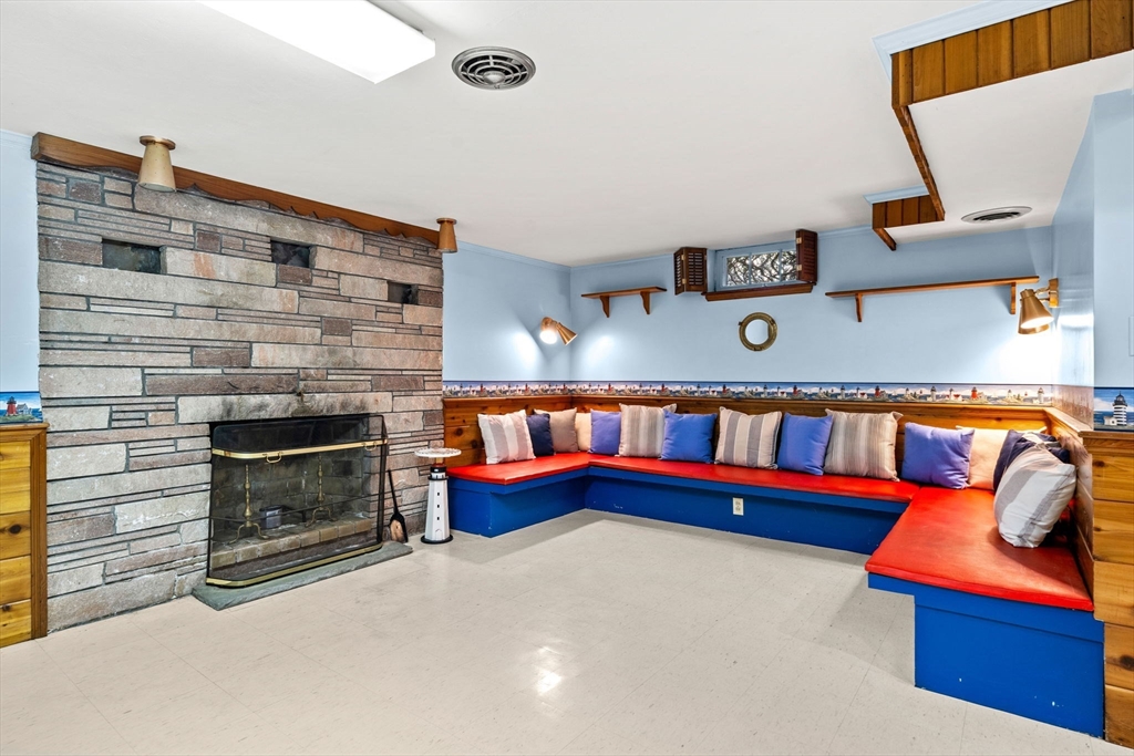 1 Ledgewood Road Wilmington, MA 01887 - Photo 24 of 36 a living room with furniture and a fireplace