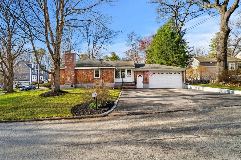 1 Ledgewood Road Wilmington, MA 01887 - Photo 32 of 36 a view of a white house with a large tree next to a yard
