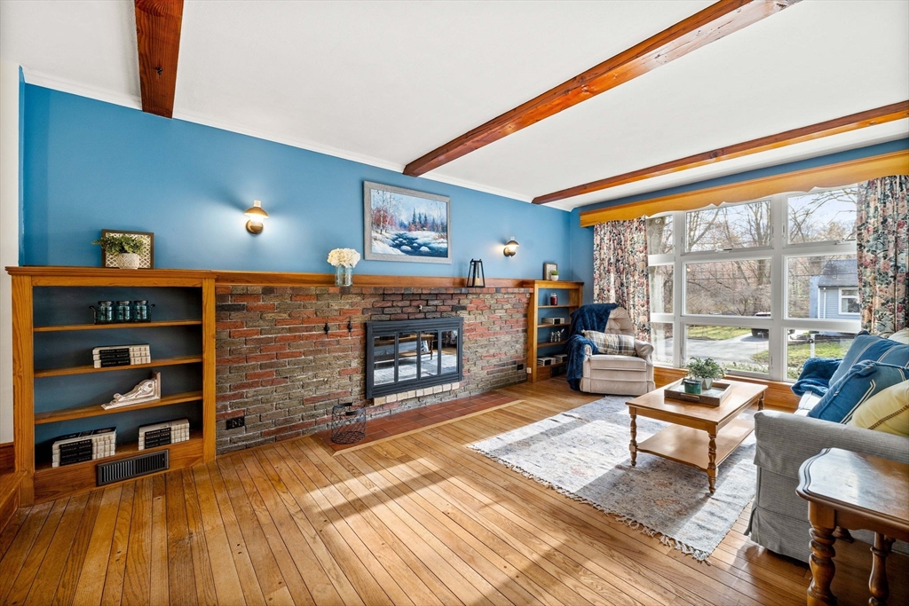 1 Ledgewood Road Wilmington, MA 01887 - Photo 10 of 36 a living room with furniture a rug and a floor to ceiling window