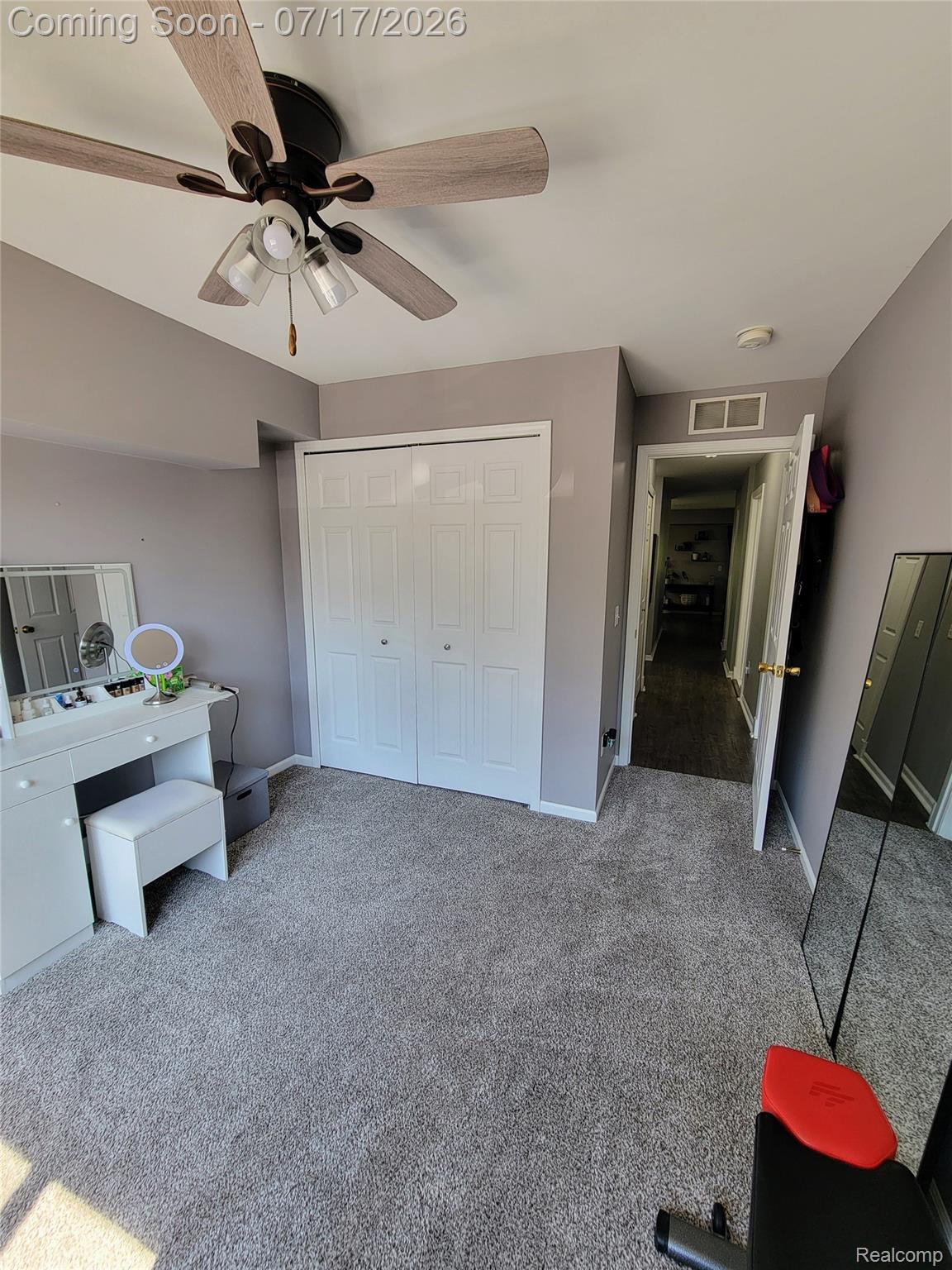 1655 Riverside Drive, Unit 10 Rochester, MI 48309 - Photo 37 of 44 Recessed closet with bi-fold doors, grey carpet flooring, and a ceiling fan with integrated lighting