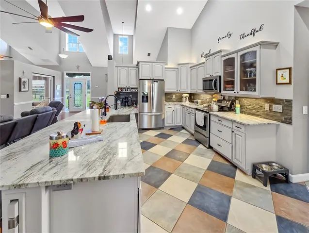 a kitchen with stainless steel appliances granite countertop a sink and cabinets