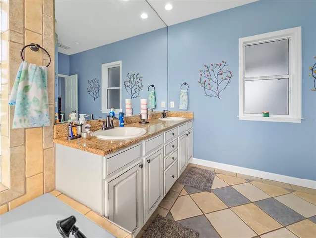 a spacious bathroom with a double vanity sink mirror and