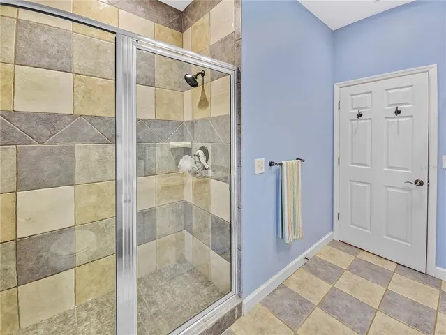 a bathroom with a glass shower door