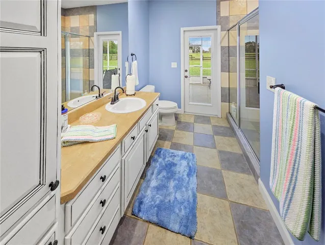a bathroom with a double vanity sink a mirror and a shower