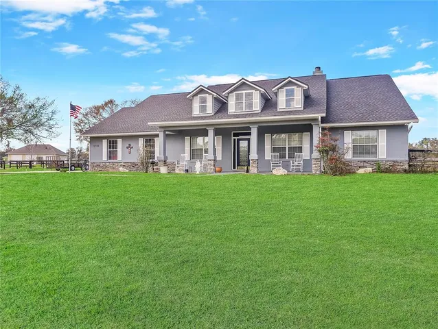 a front view of a house with a garden and plants