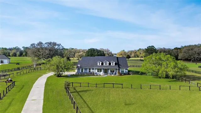 an aerial view of a house with a big yard