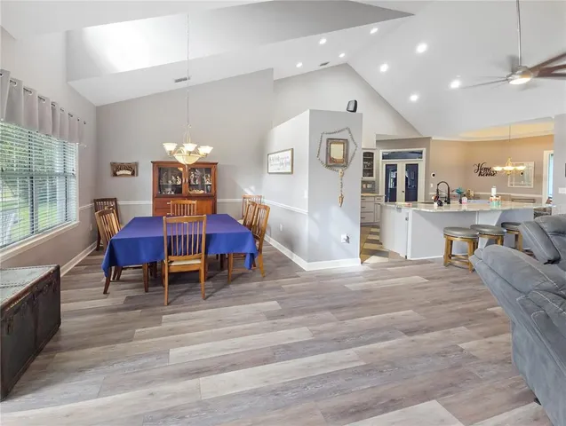 a living room with furniture and kitchen view