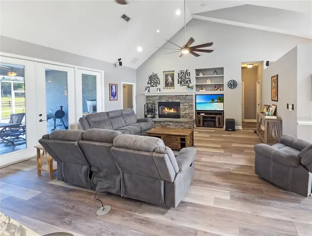 a living room with furniture a fireplace and a flat screen tv