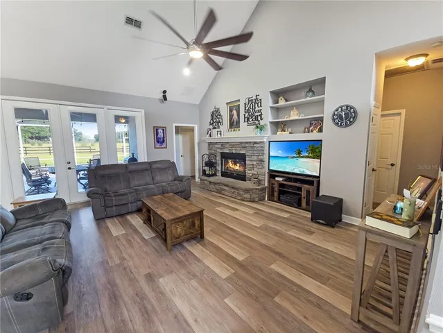 a living room with furniture flat screen tv and a fireplace