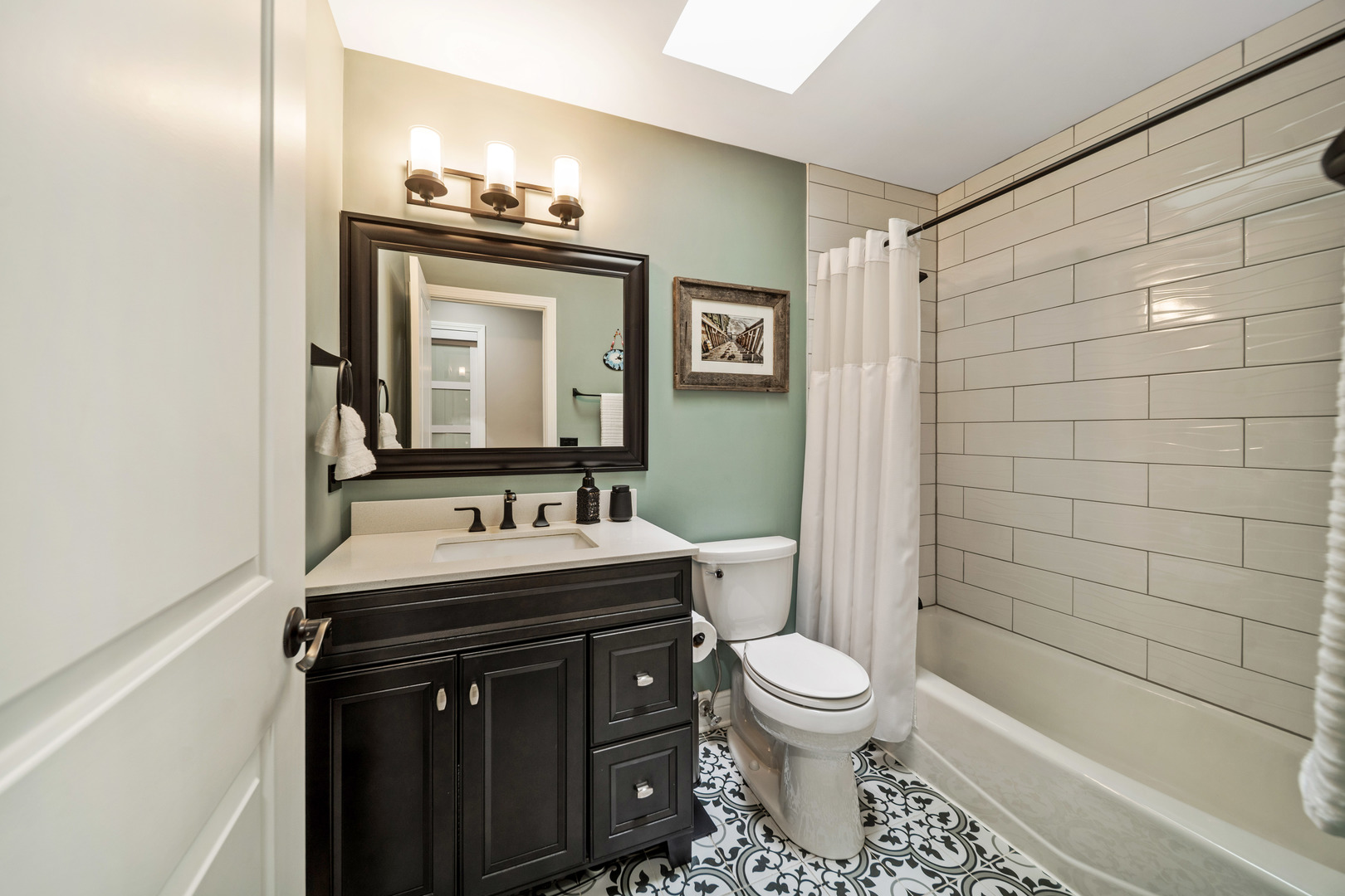 28W140 Mack Road Wheaton, IL 60189 - Photo 19 of 48 a bathroom with a sink a toilet and mirror