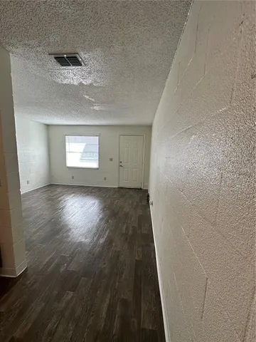 a view of outdoor space with a garden and car parked