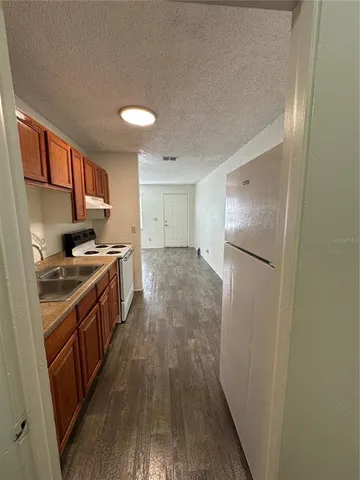 a kitchen with a refrigerator and a stove