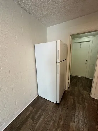 a view of a room with wooden floor and white walls