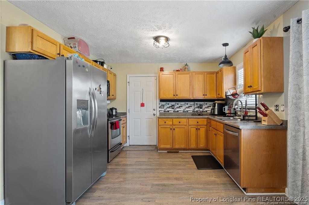 717 Lenoir Drive Spring Lake, NC 28390 - Photo 12 of 47 a kitchen with stainless steel appliances granite countertop a refrigerator a stove and a sink