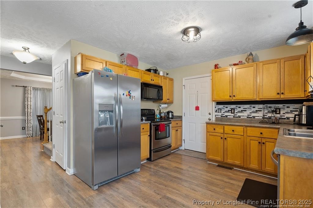 717 Lenoir Drive Spring Lake, NC 28390 - Photo 15 of 47 a kitchen with stainless steel appliances granite countertop a refrigerator and a stove top oven