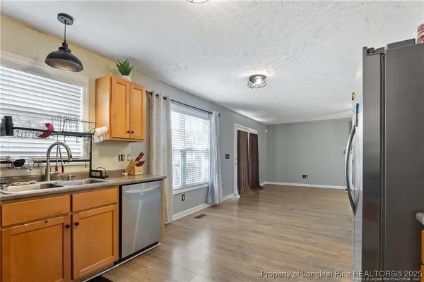 a kitchen with stainless steel appliances a refrigerator sink and cabinets