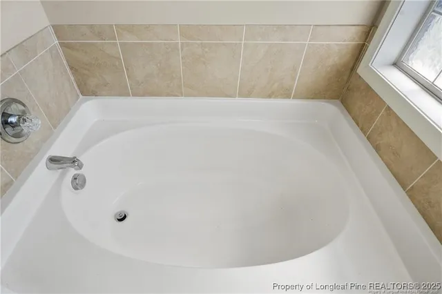 a bathroom with a sink a toilet a mirror a vanity and shower