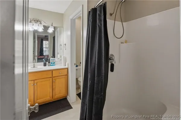 a bathroom with a mirror and a shower