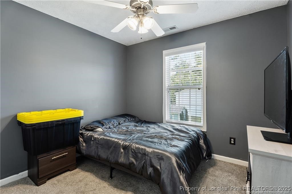 717 Lenoir Drive Spring Lake, NC 28390 - Photo 27 of 47 a bedroom with a bed and a tv