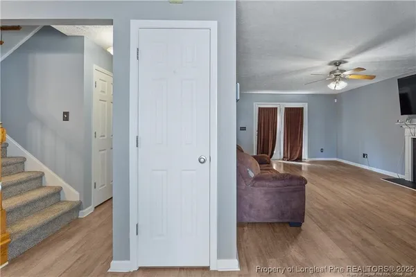 a view of a hallway with wooden floor and workspace